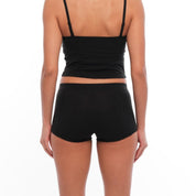 a woman wearing a black bralette and black boy shorts from the back