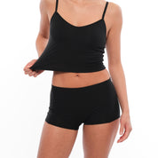 a woman wearing black boy shorts with a matching black bralette