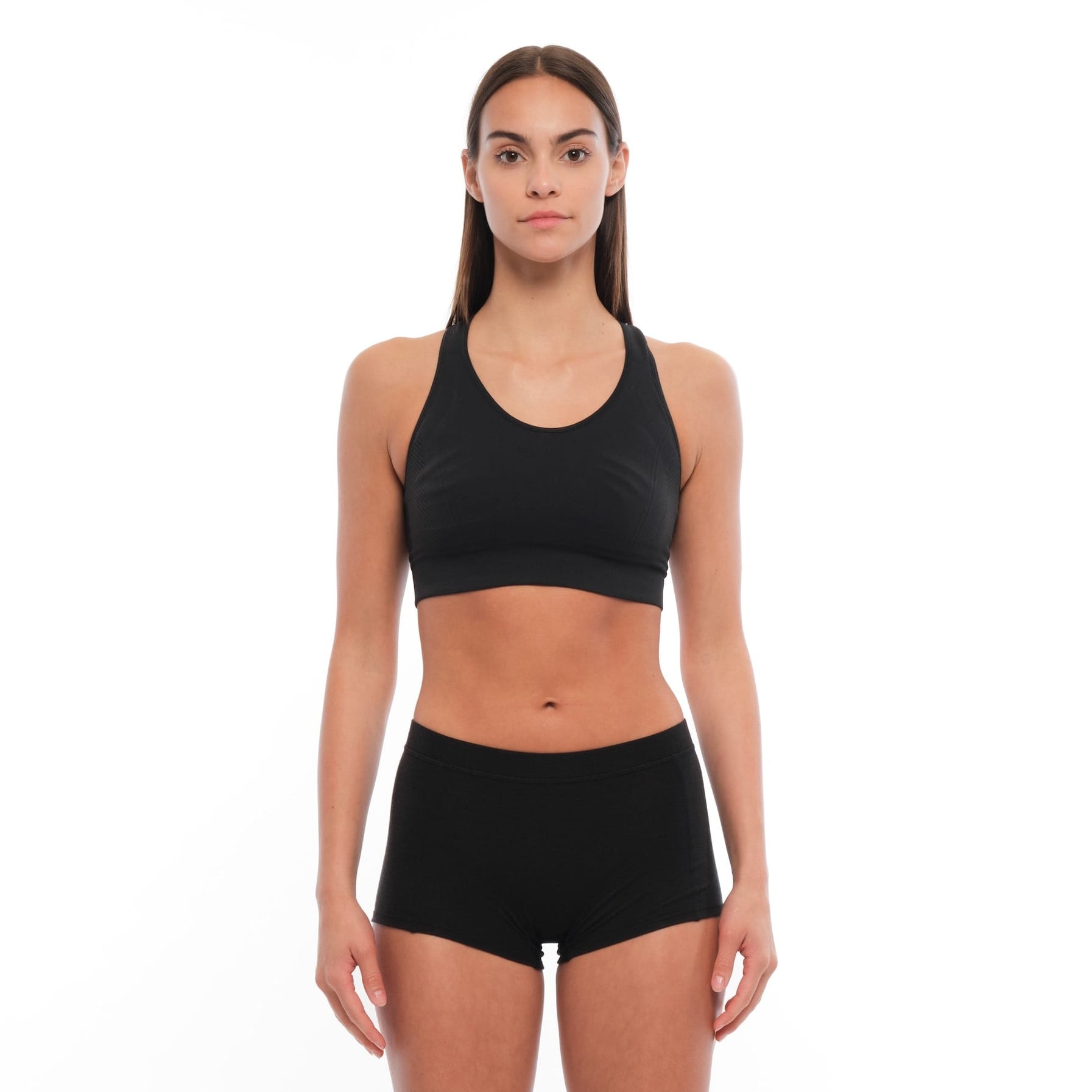a woman wearing a Ridge Merino wool sports bra with matching black Merino boy shorts