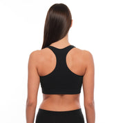 a woman wearing a Ridge Merino Wool Sports Bra from the back