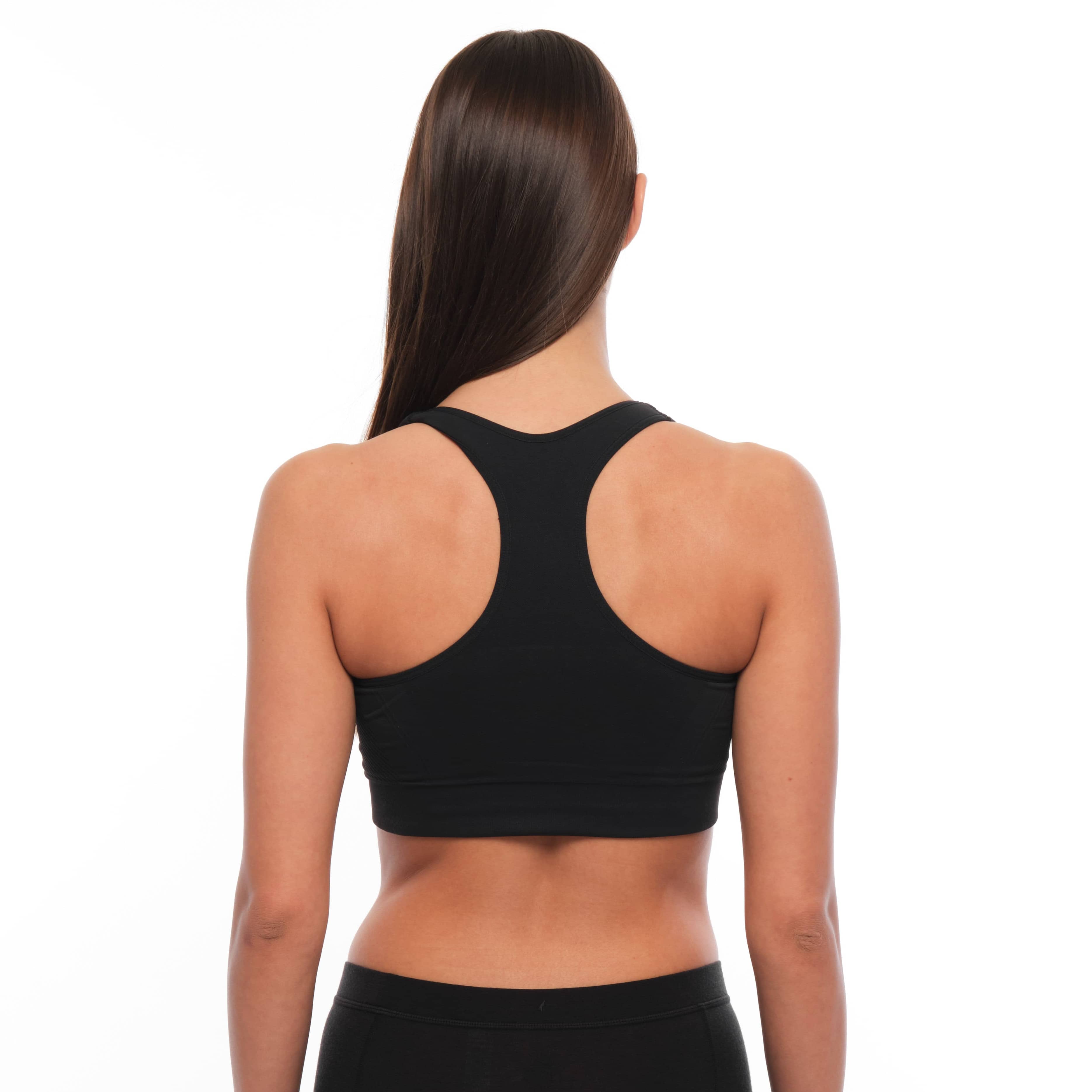 a woman wearing a Ridge Merino Wool Sports Bra from the back
