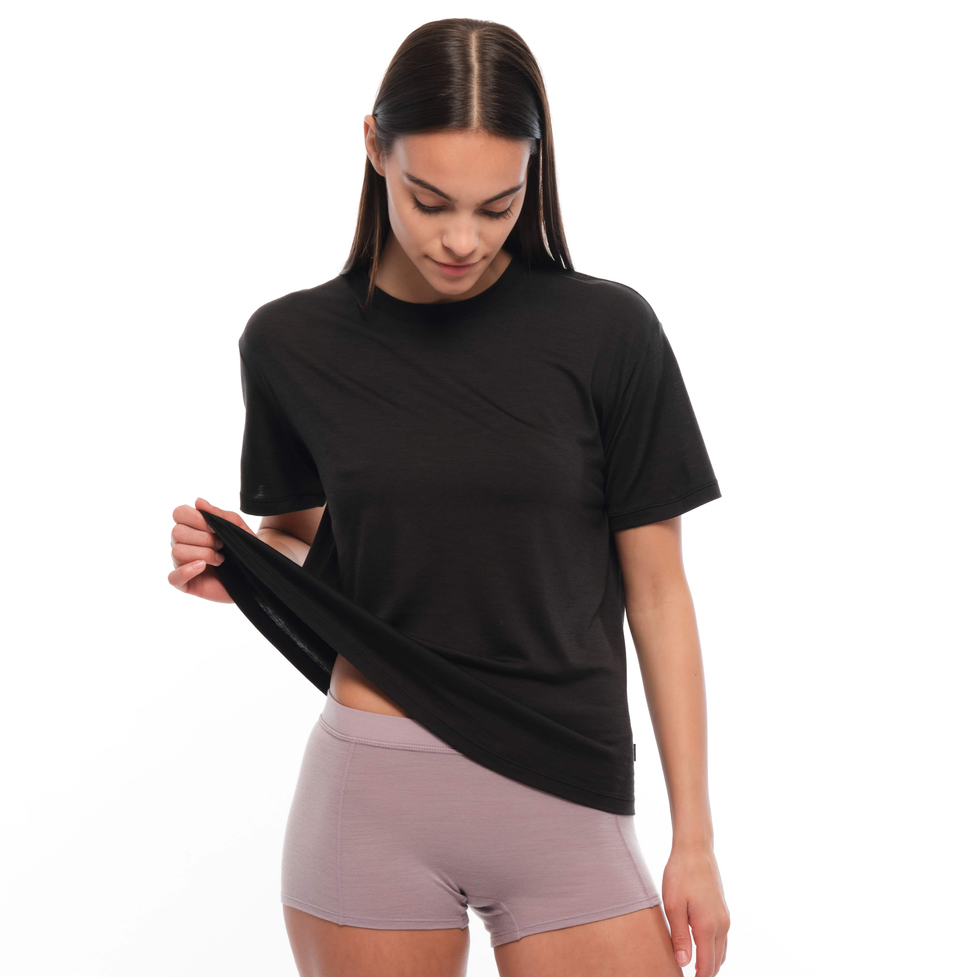a woman wearing a black Canopy Merino Tencel T-shirt with pink boy shorts