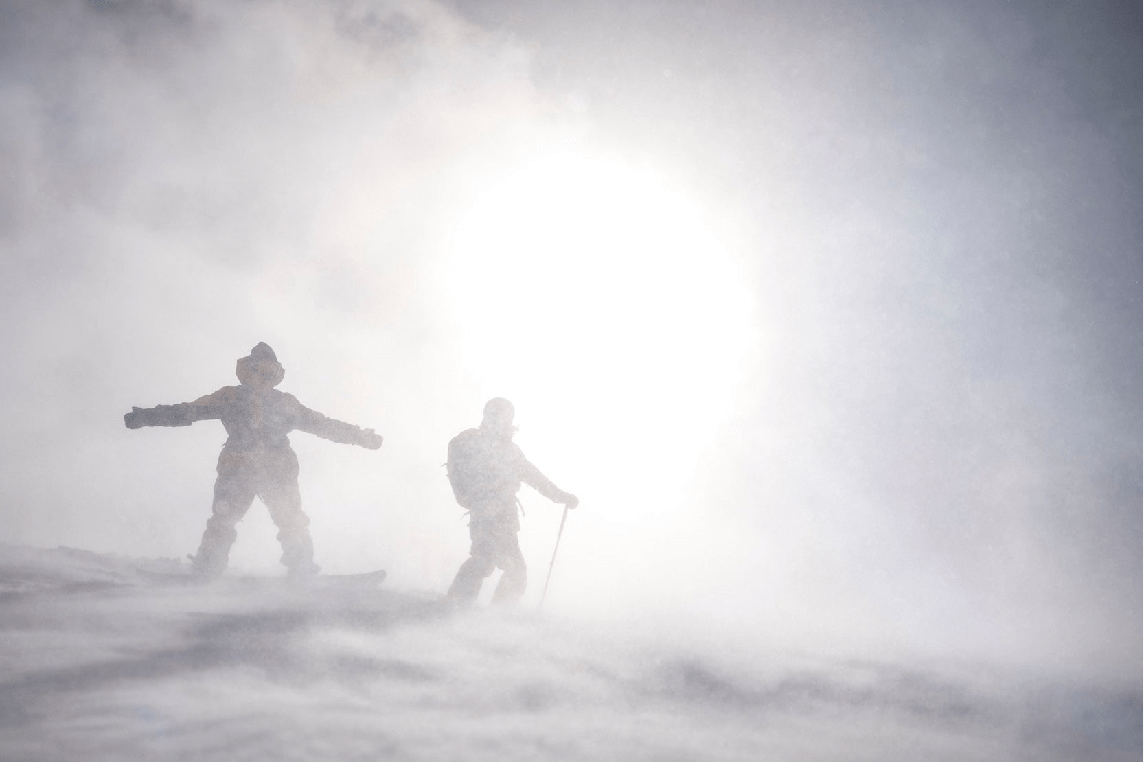 Two skiers in a whiteout
