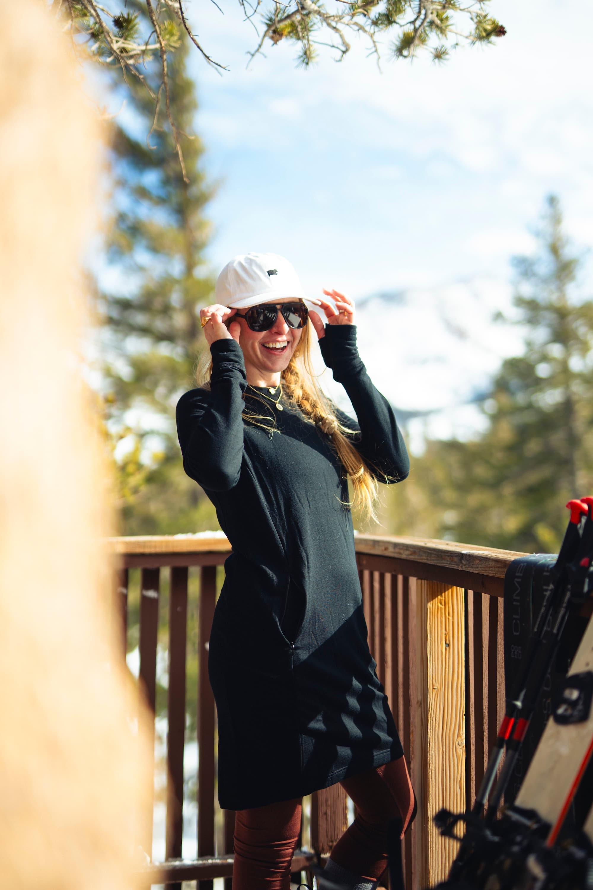 a woman smiling wearing a black Hyde 100% Merino dress with pockets