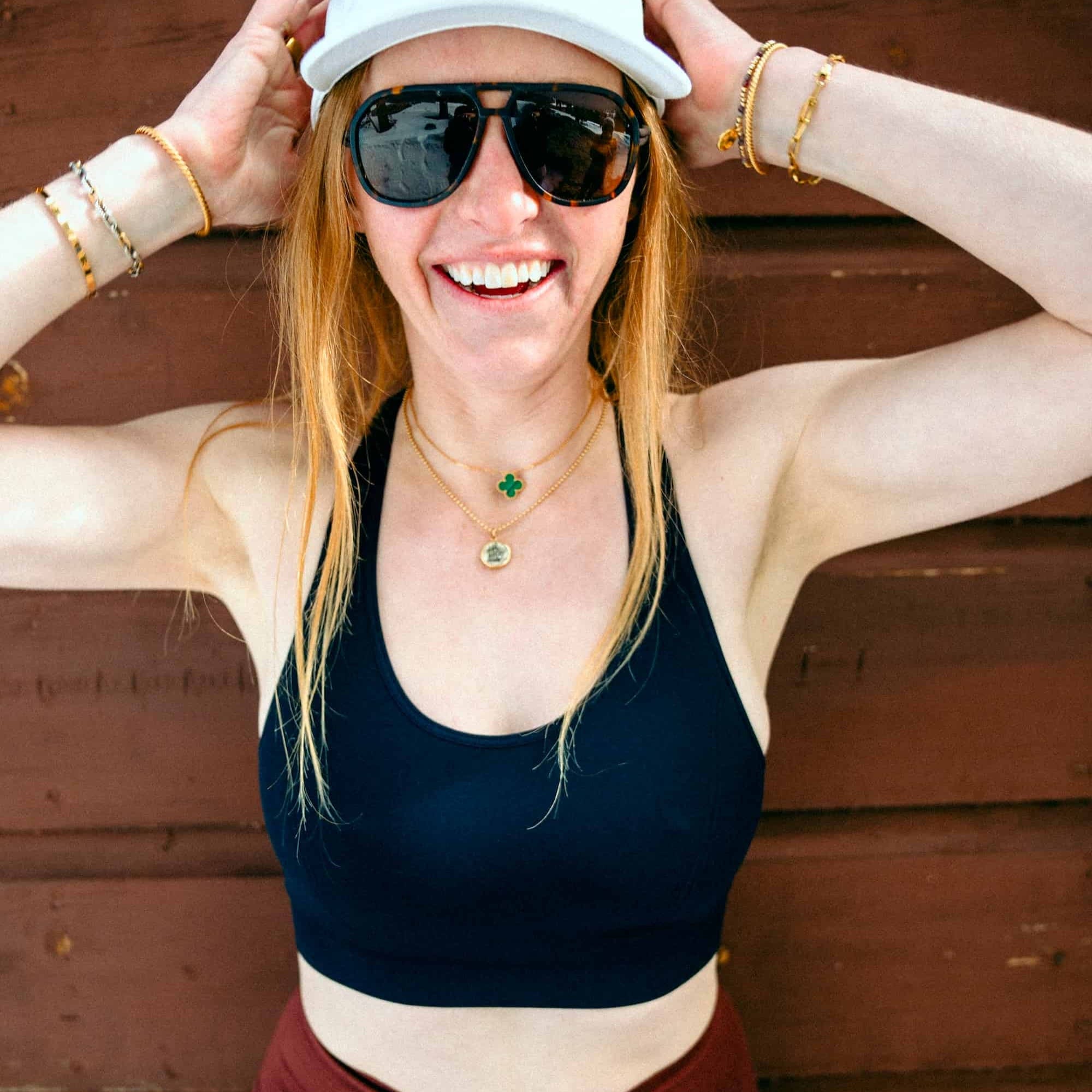a woman smiles wearing a Ridge Merino sports bra