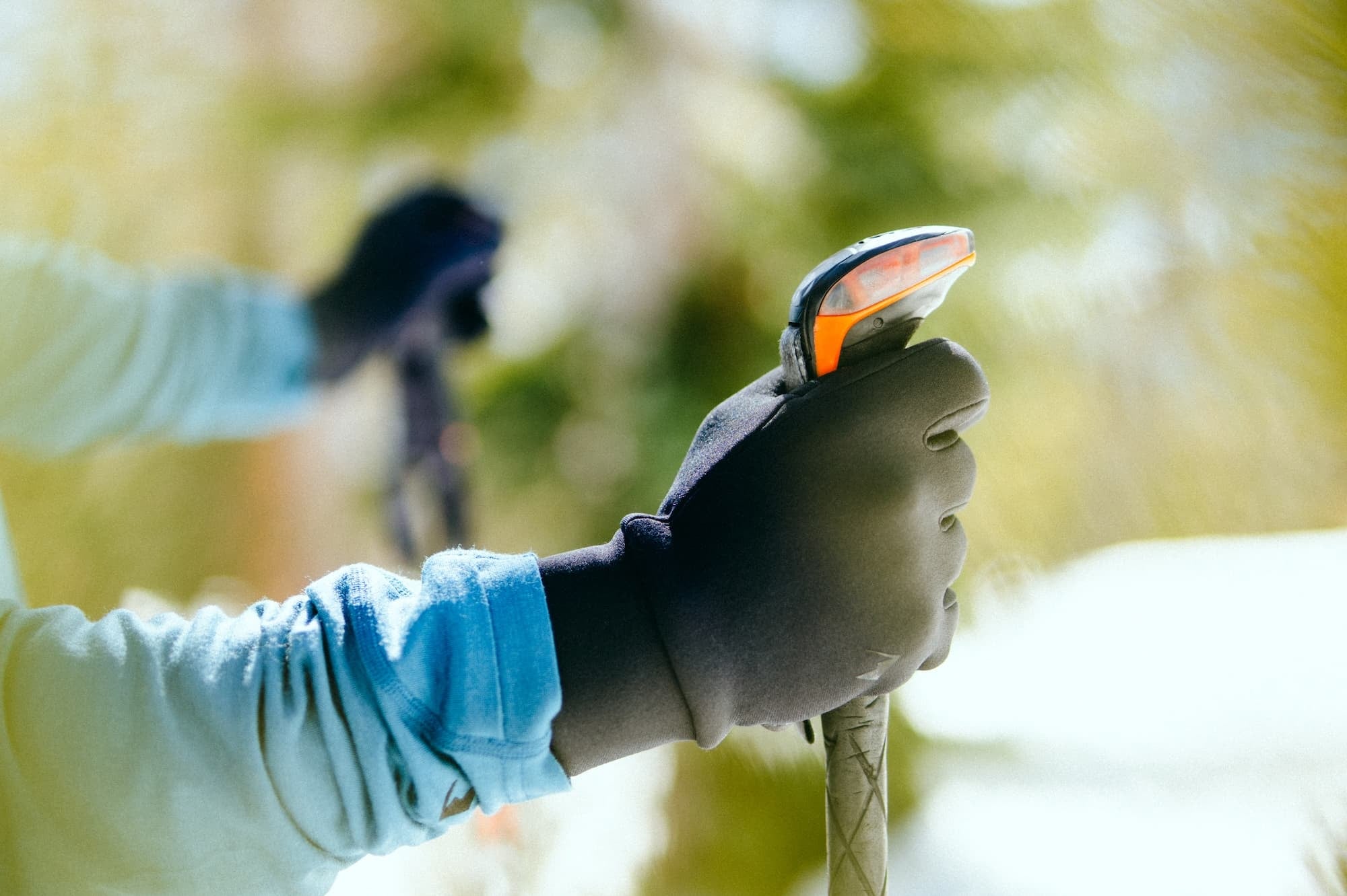 closeup of a skier's hands in Northwind Fleece Gloves holding ski poles