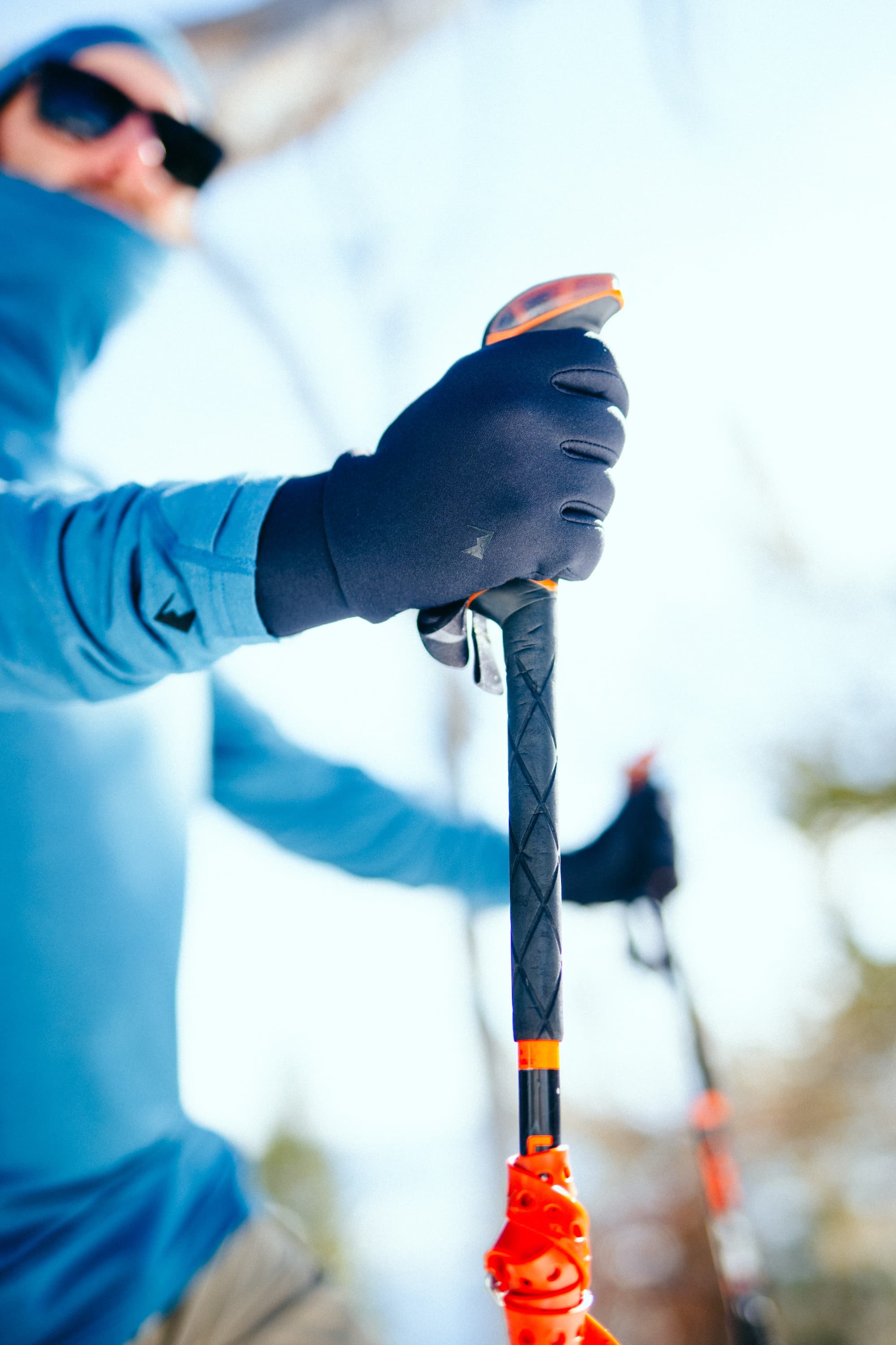 a skier wearing Northwind Fleece Gloves and an Aspect Balaclava Hood on a ski day