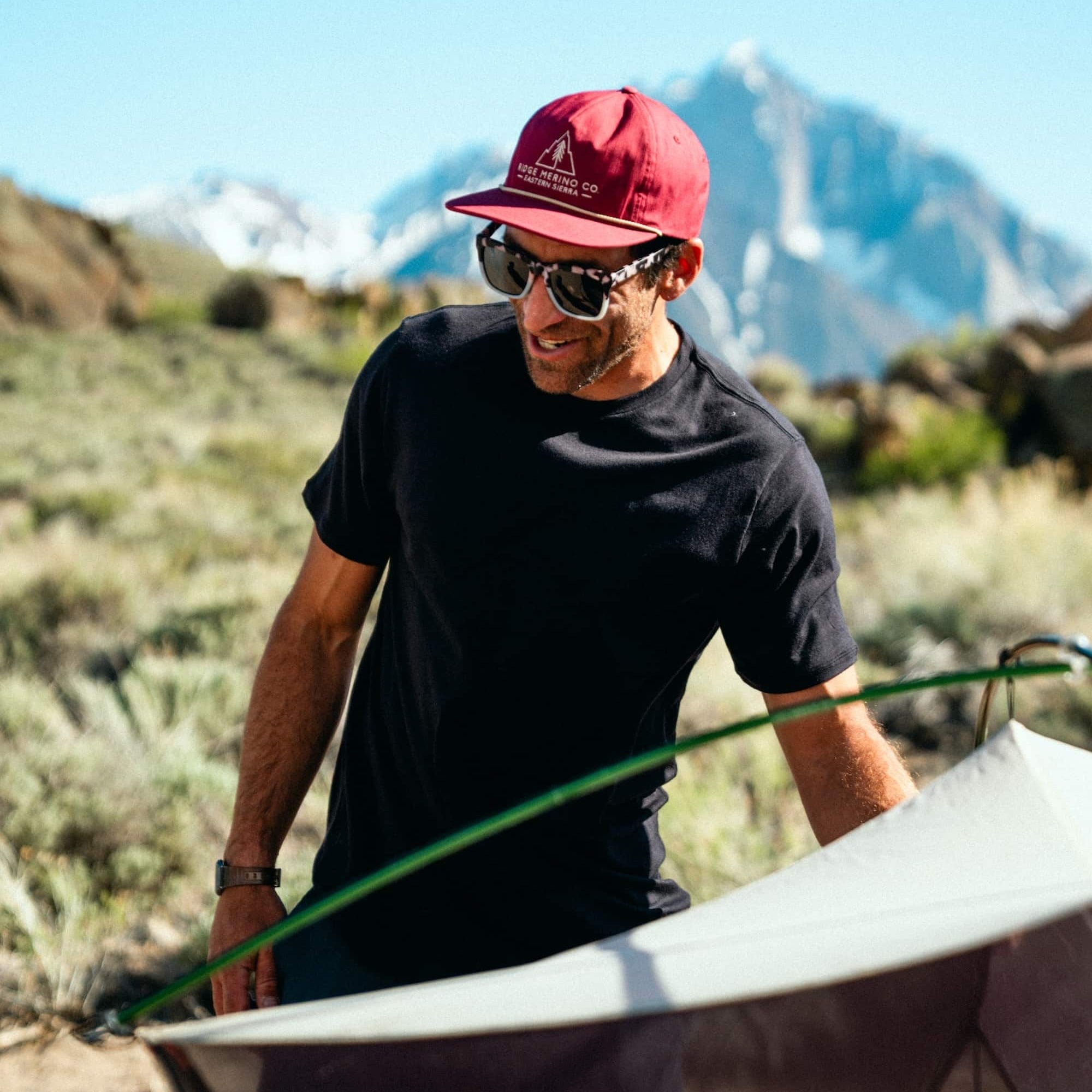 a man camping wearing a Journey Merino Wool Tee