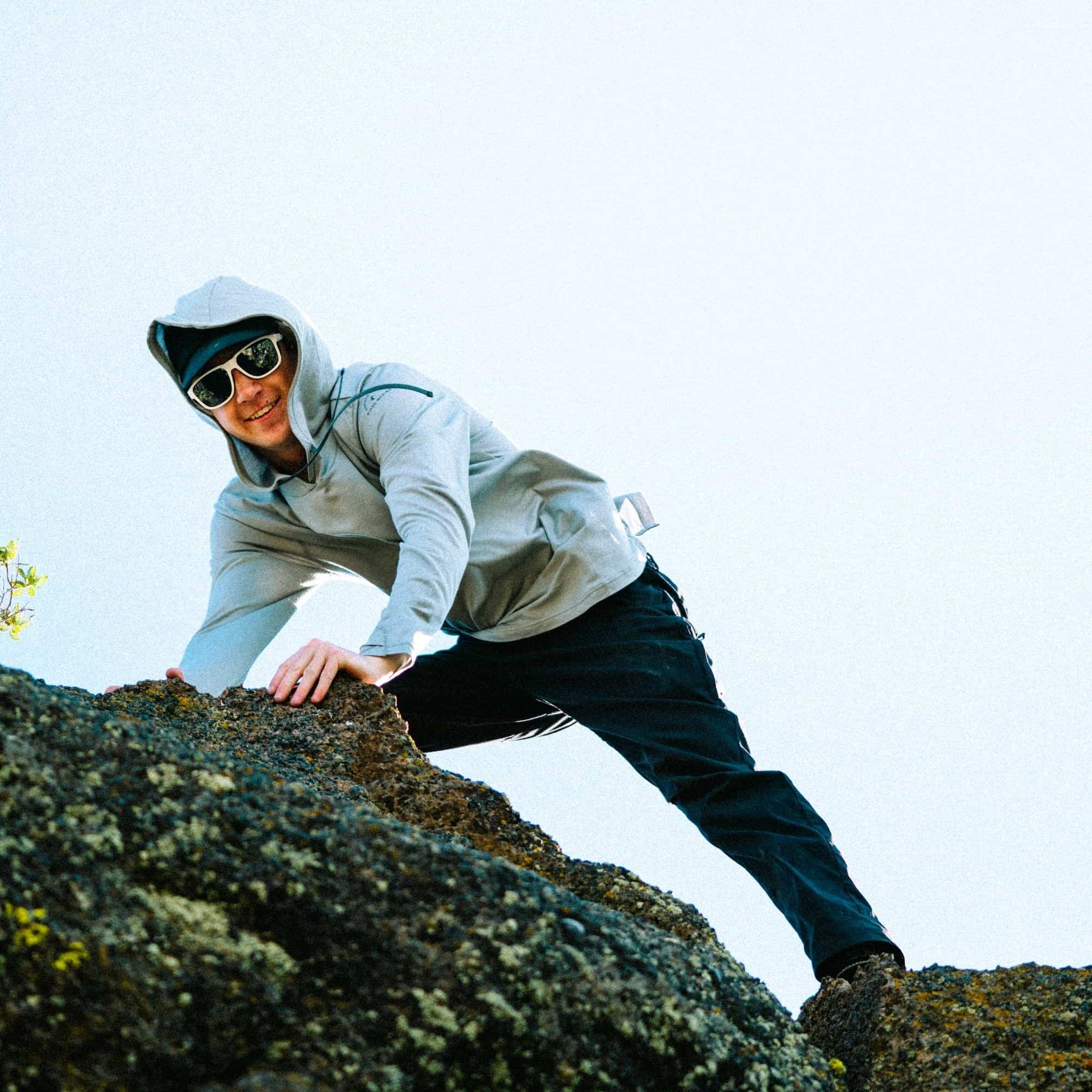 a man wearing a Ridge Merino Solstice Sun Hoodie