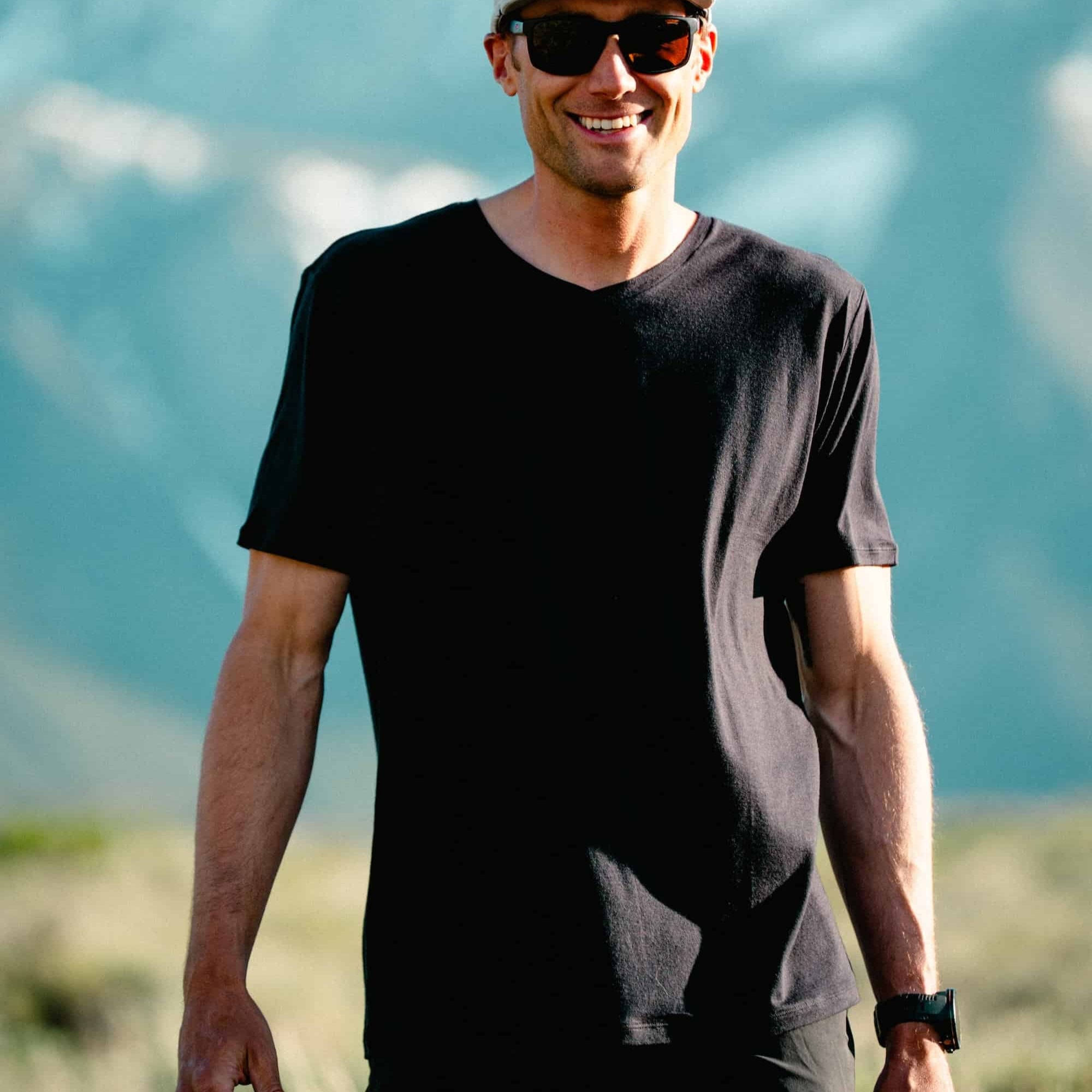 a man wearing a black Journey V-Neck Tee