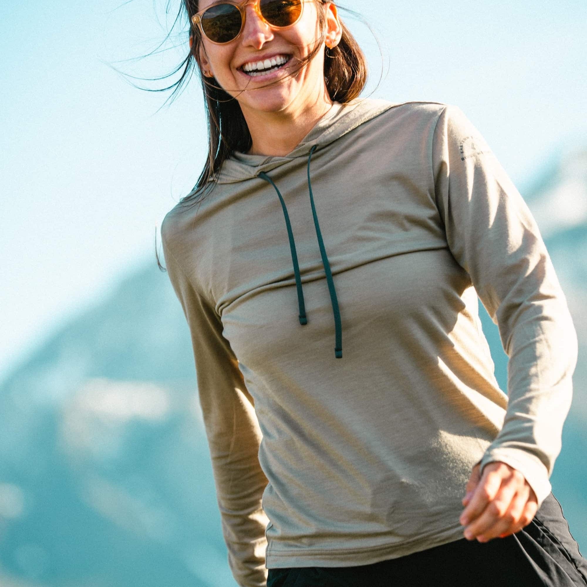a woman wearing a Driftwood Solstice Sun Hoodie