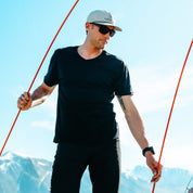 a man setting up a tent wearing a Journey V-Neck T-shirt