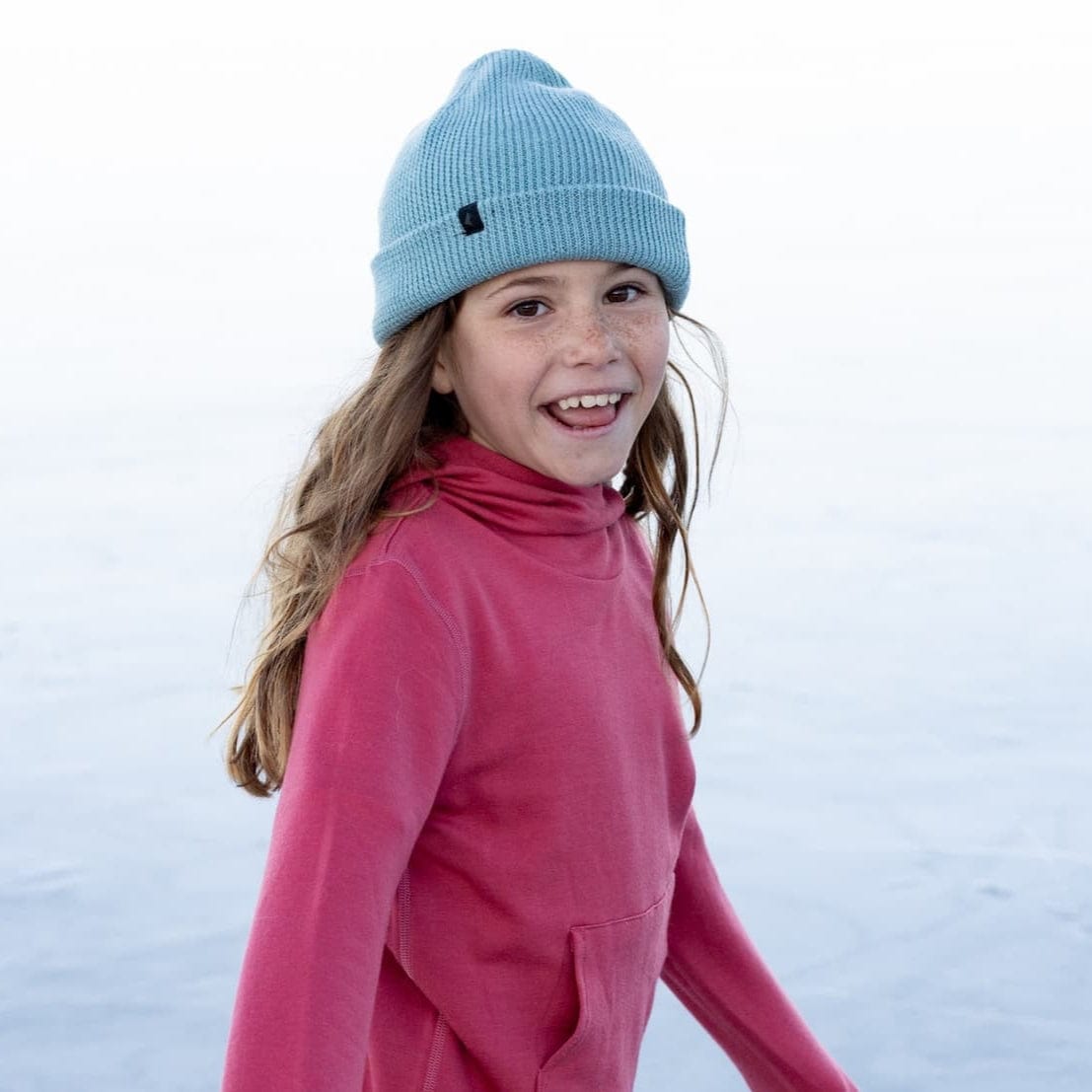 a girl ice skating wearing a Kids' Layton Merino Wool Beanie