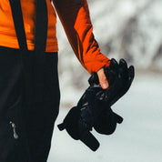 a woman holding a pair of black Tioga Tour Gloves