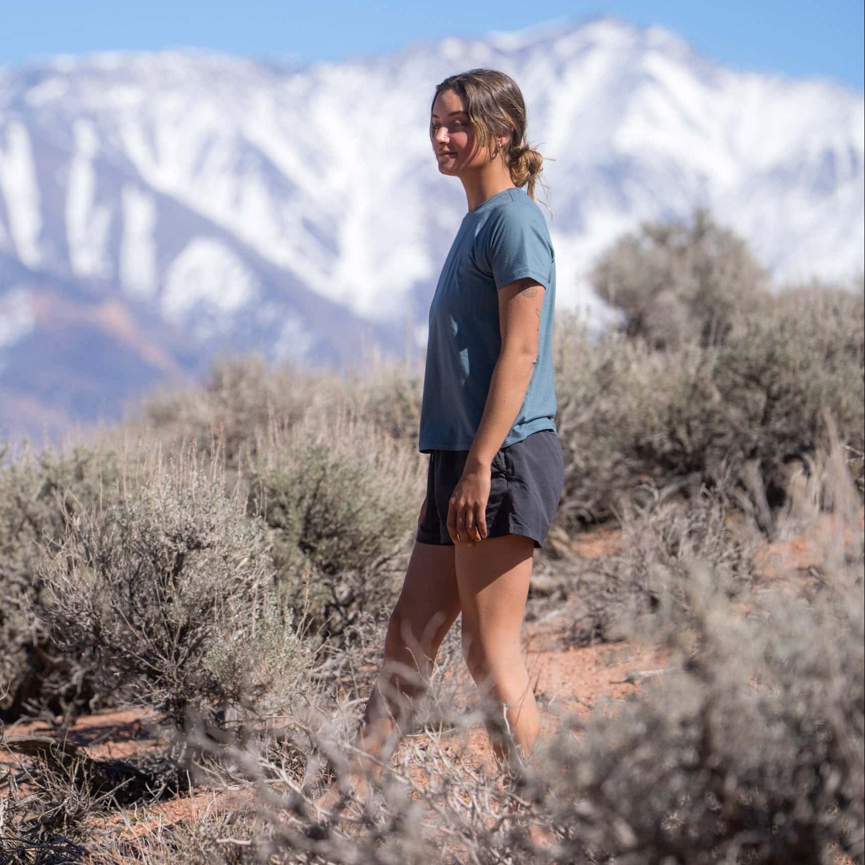 a woman on a hike wearing a blue Canopy Merino Tencel Tee