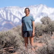 a woman on a hike wearing a blue Canopy Merino Tencel Tee