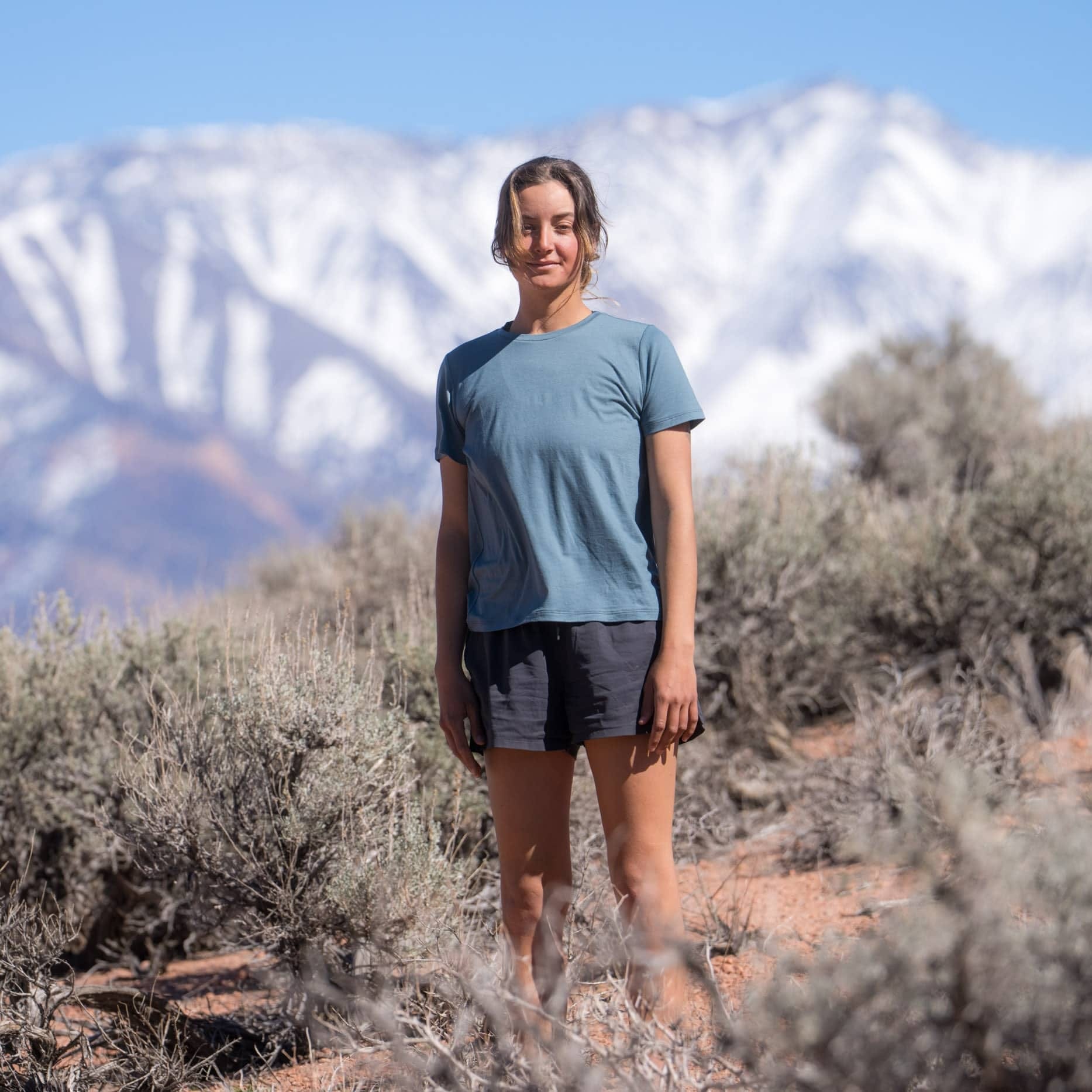 a woman on a hike wearing a blue Canopy Merino Tencel Tee