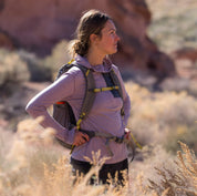 a hiker wearing a Dusty Lilac Solstice Pro Sun Hoodie