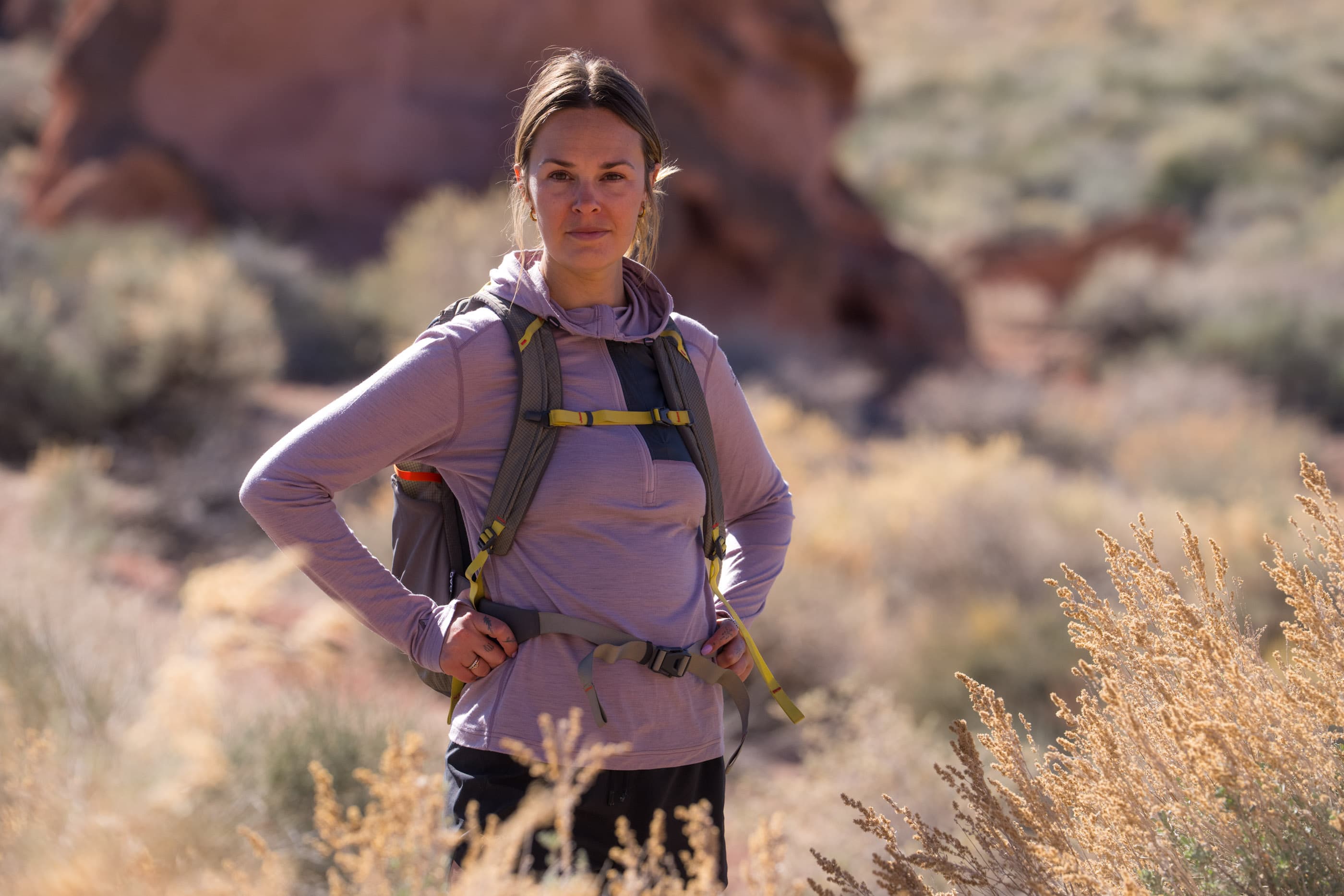 a hiker wearing a Solstice Pro Sun Hoodie in DUsty Lilac