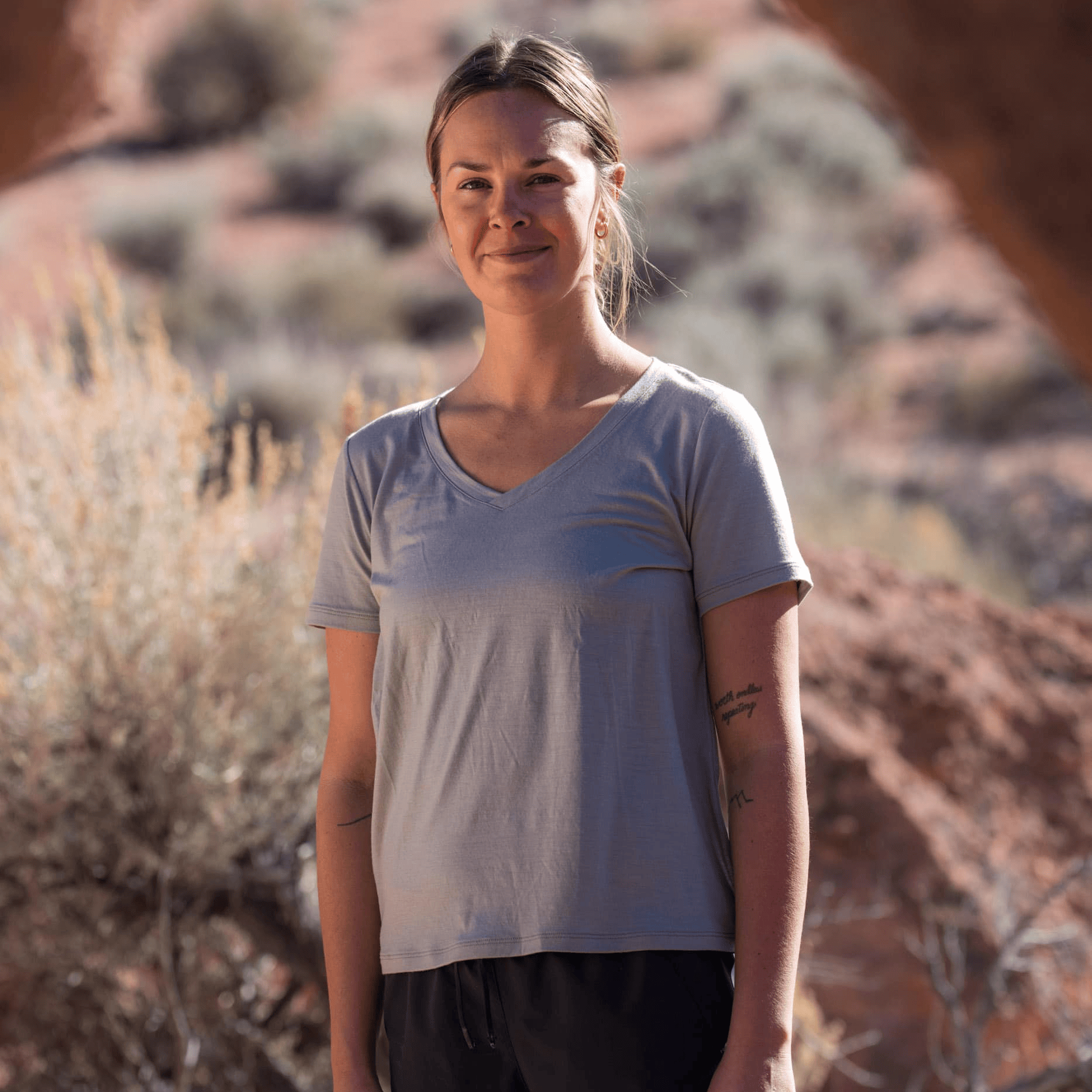 a woman wearing a v-neck Merino wool t-shirt