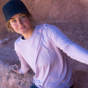 a woman wearing a pink long sleeve Merino/Tencel shirt