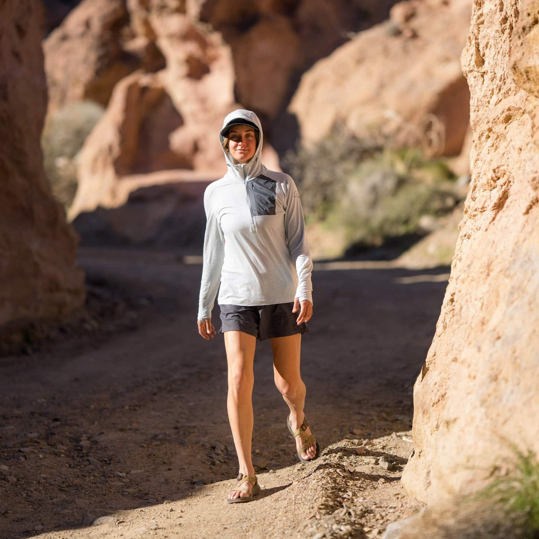 a woman walking wearing a gray Solstice Sun Hoodie