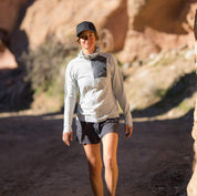 a woman walking wearing a gray Solstice Sun Hoodie