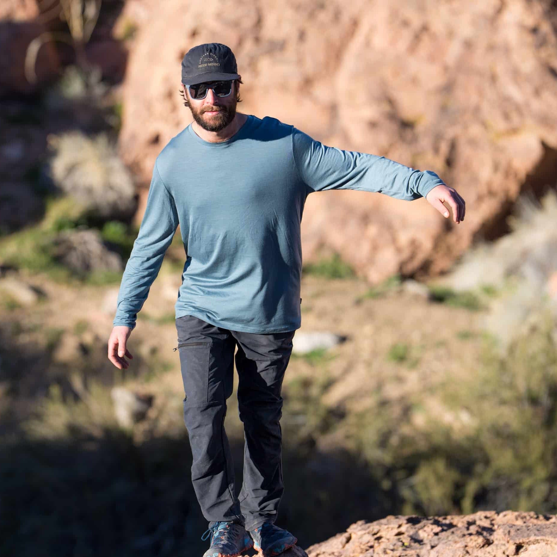 a man walking in a blue long sleeve shirt