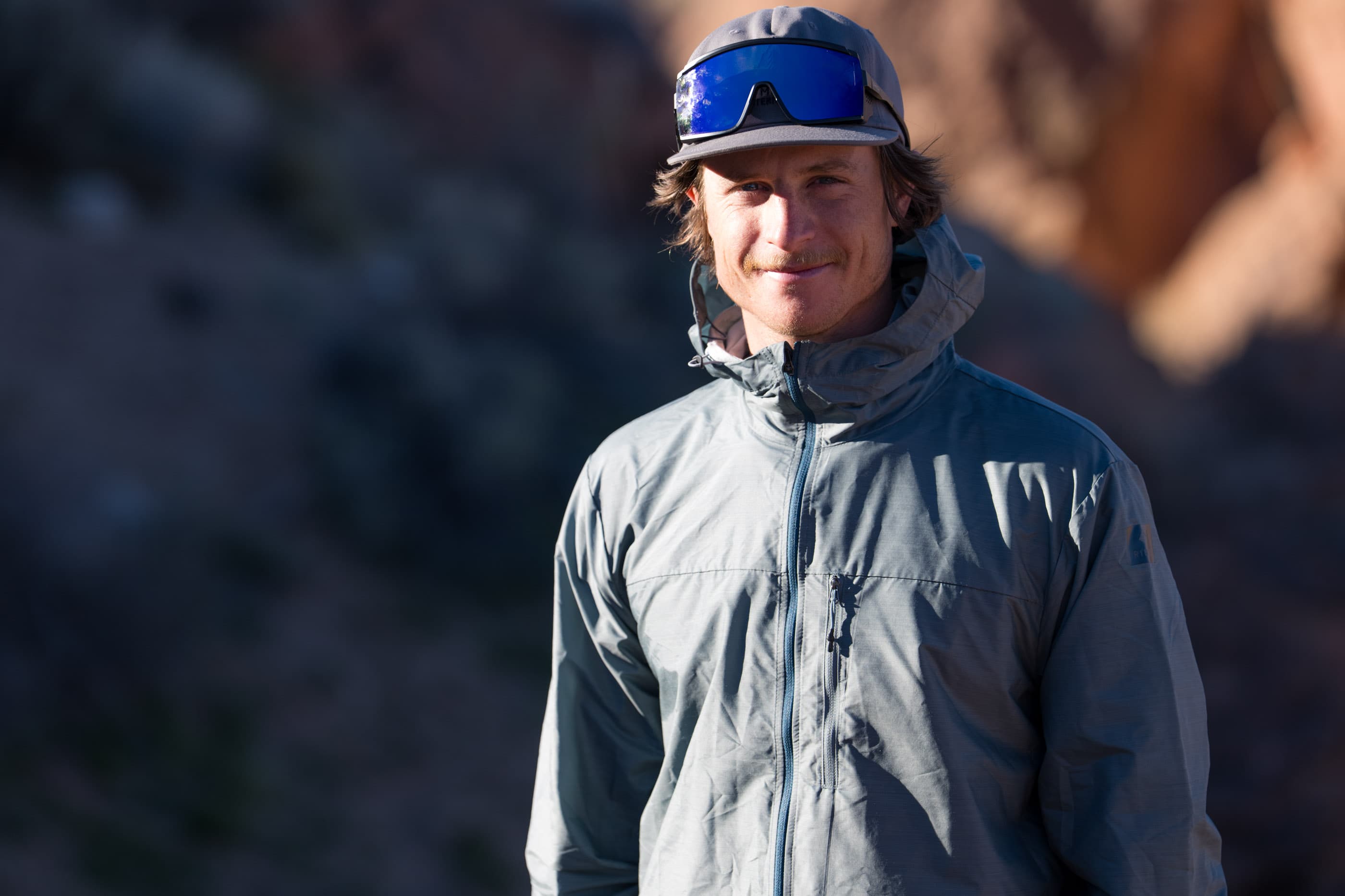 a man smiles wearing a Windshifter Windbreaker and sunglasses