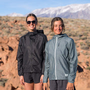 two hikers standing together both wearing Ridge Merino Windbreakers