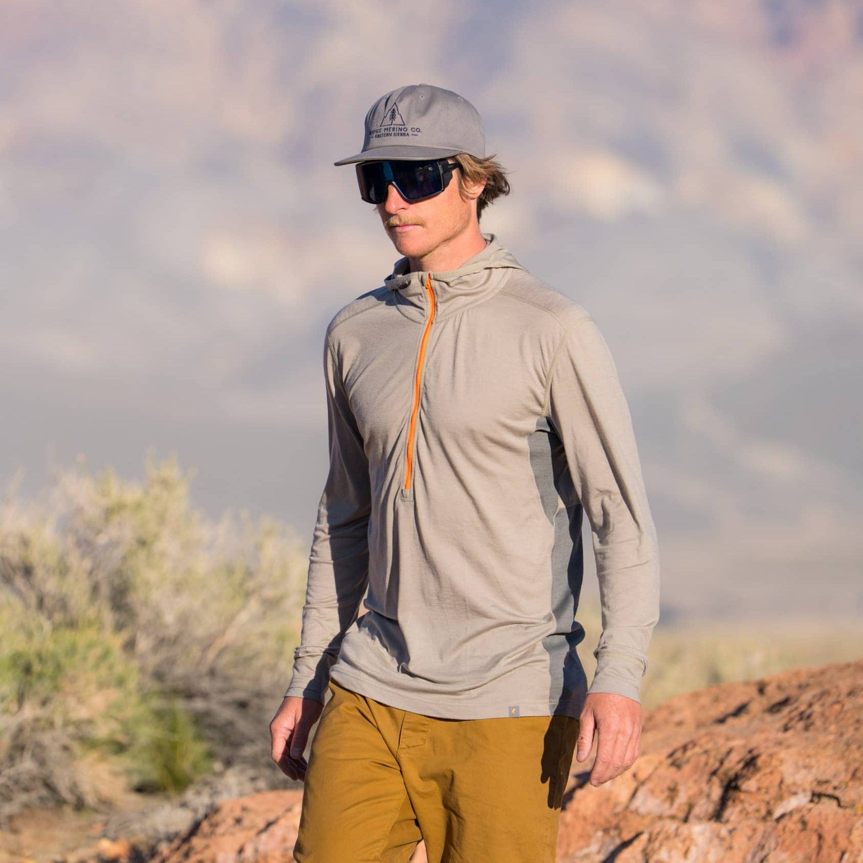 a hiker wearing a Pursuit Air Ultralight Hoodie and sunglasses