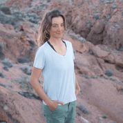 a woman smiles wearing a Ridge Merino V-Neck Tee