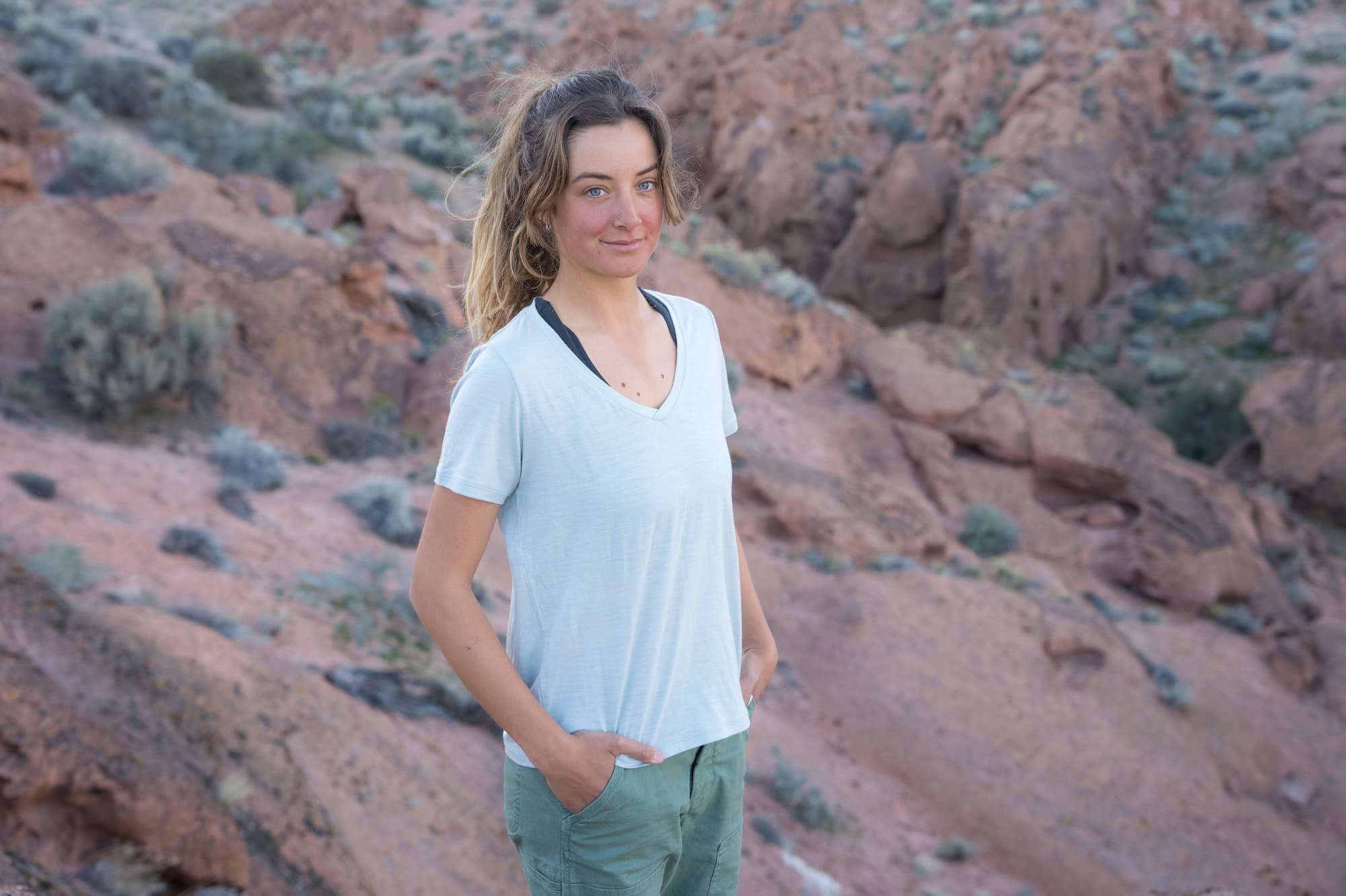 a woman standing in the desert wearing a Journey V-neck T-Shirt in Ice Flow