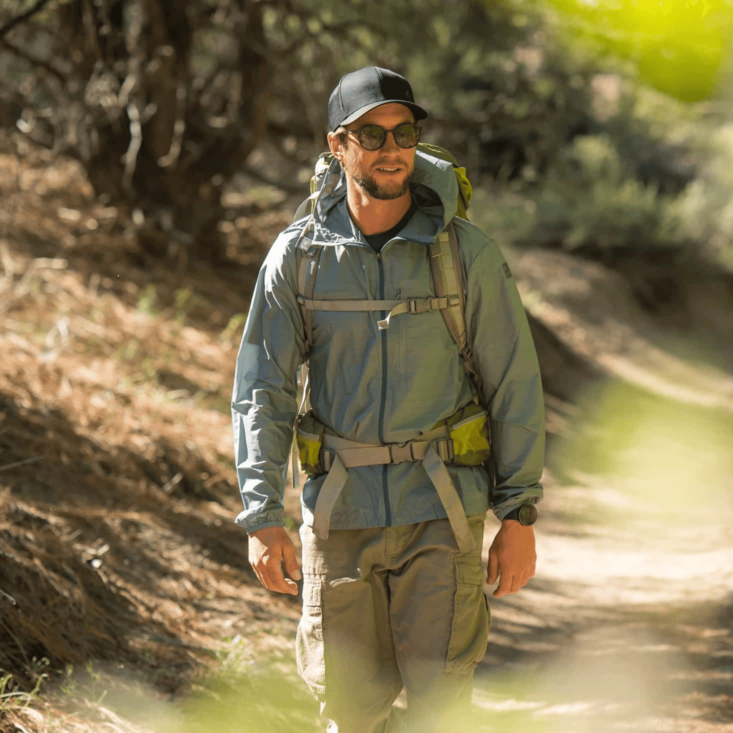 a backpacker wearing a Windshifter Windbreaker