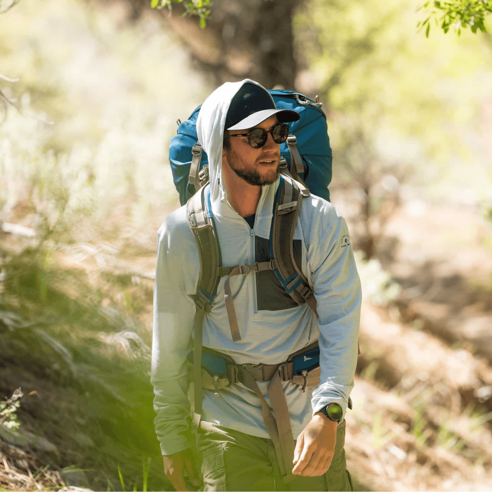 a backpacker wearing a Solstice Pro Sun Hoodie