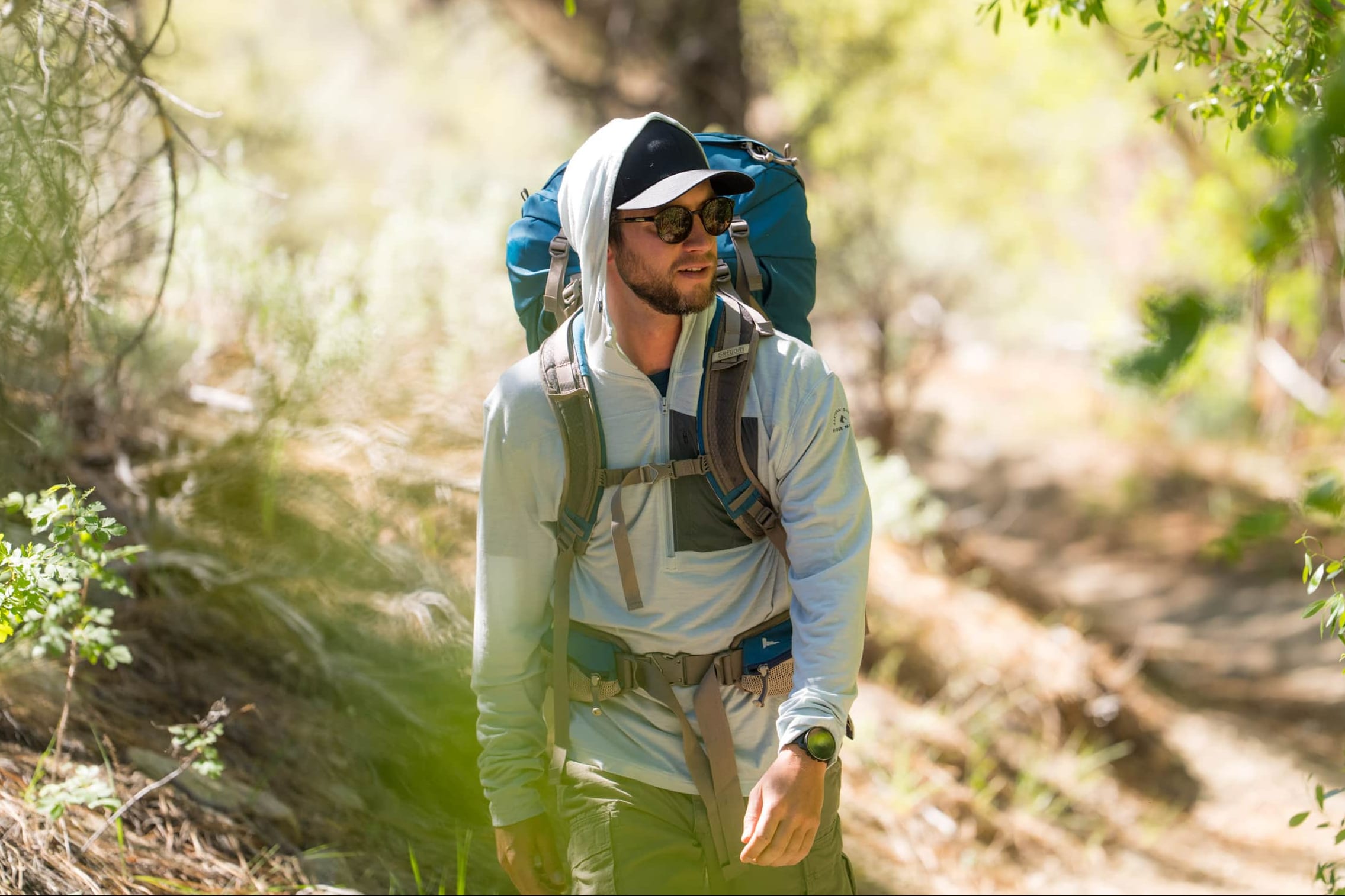 man backpacking in a Solstice Pro Sun Hoodie