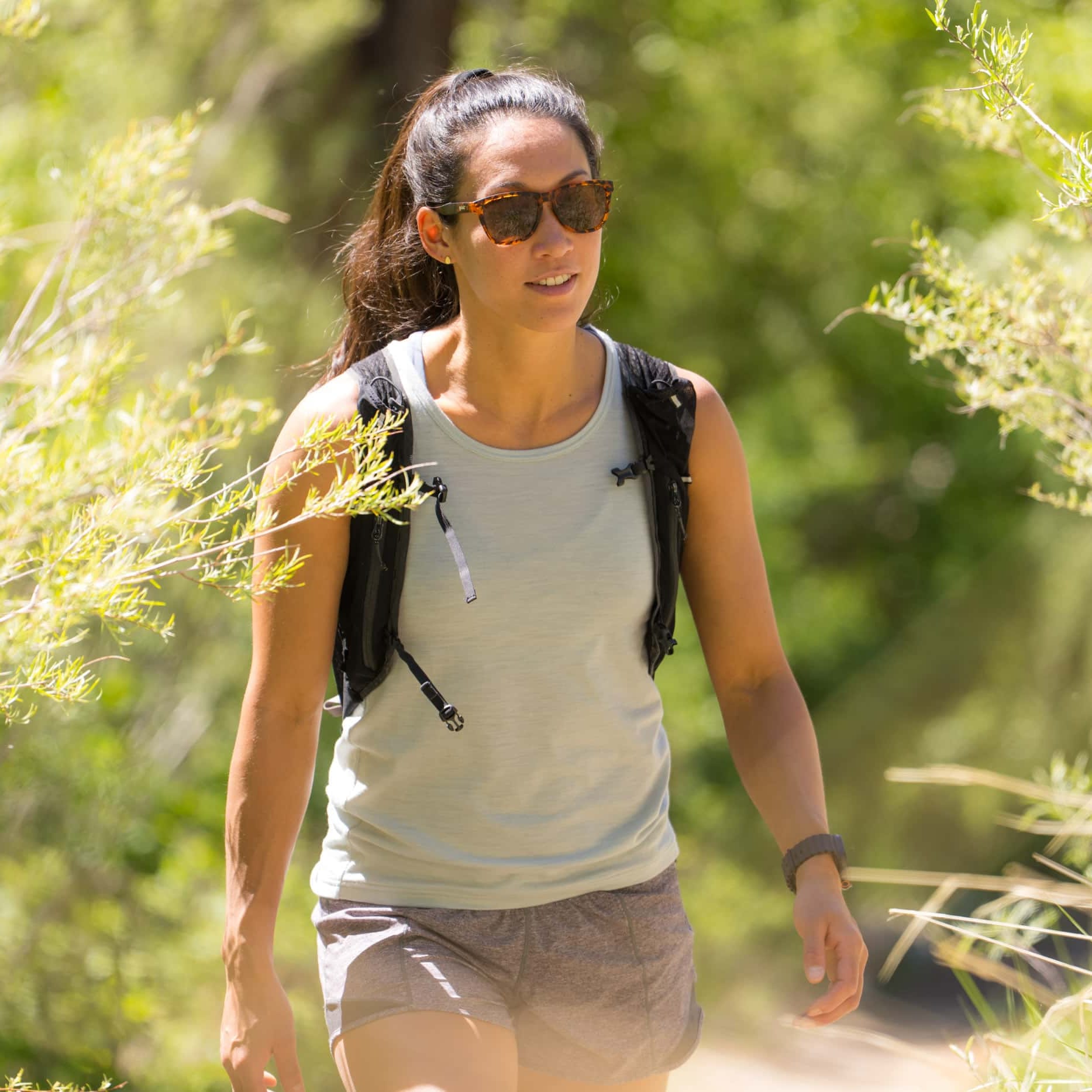 a woman hiking wearing a Journey Merino Tank Top