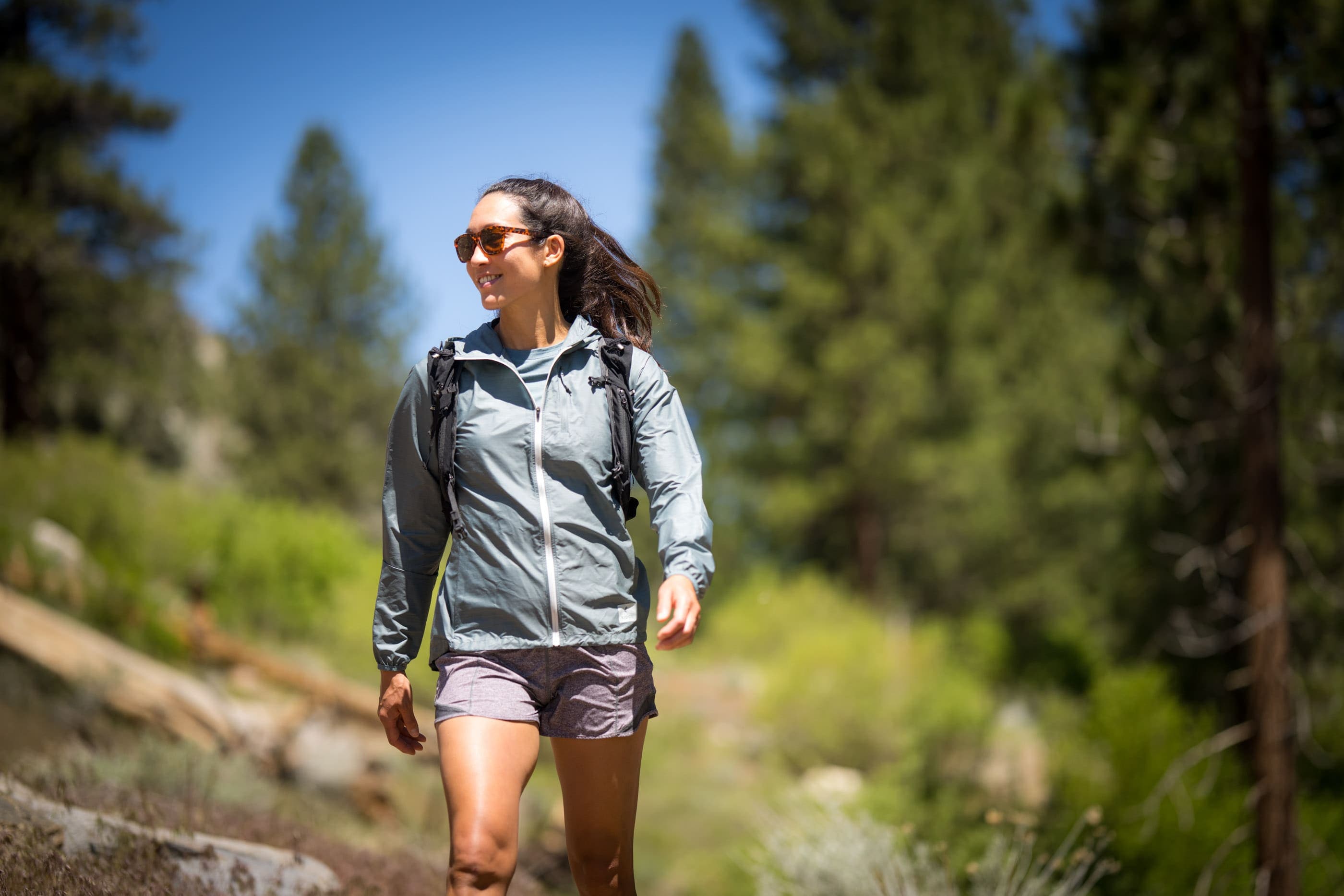 hiker smiles wearing a Windshifter Windbreaker Jacket