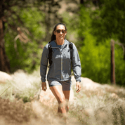 a woman hiking in a Merino Wool Windbreaker