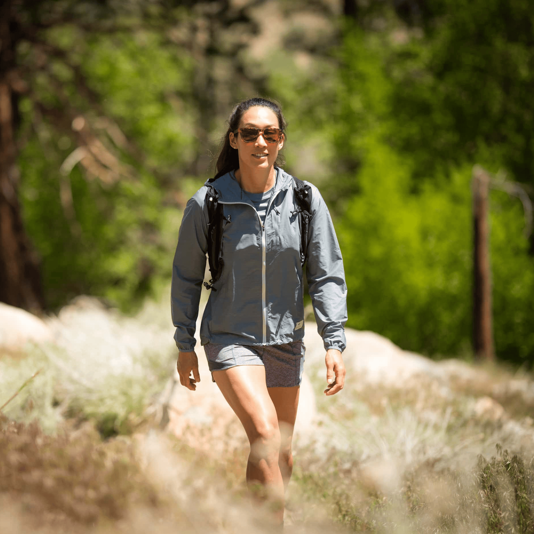 a woman hiking in a Merino Wool Windbreaker