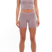 a woman wearing Dusty Lilac 5" long boy shorts with a matching Ridge Merino Bralette