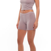 a woman wearing Dusty Lilac 5" long boy shorts with a matching Ridge Merino Bralette