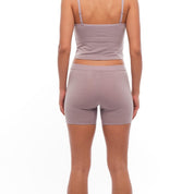 a woman from the back wearing Dusty Lilac 5" long boy shorts with a matching Ridge Merino Bralette