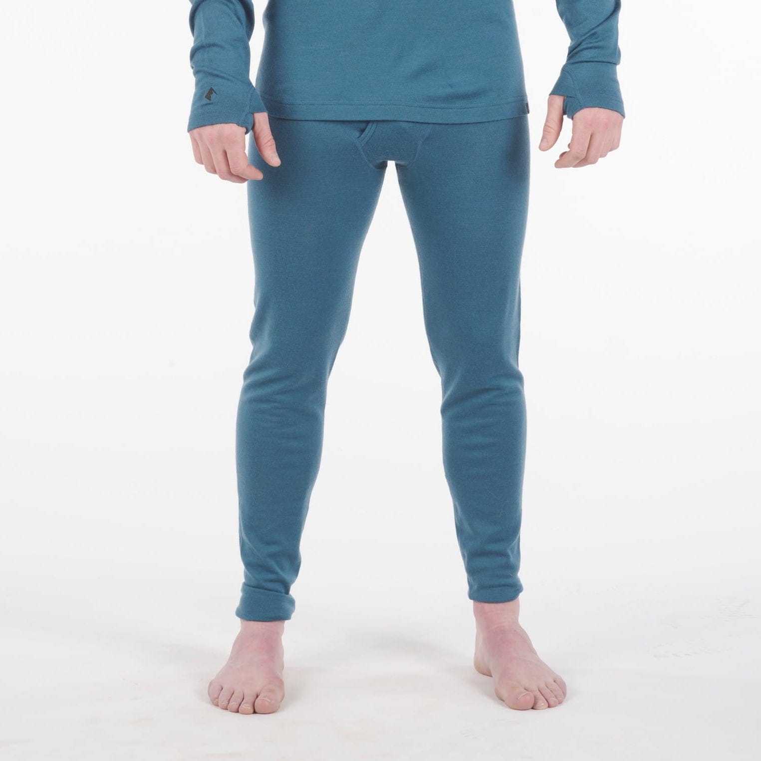 a man wearing Inversion Heavyweight Bottoms in Lagoon