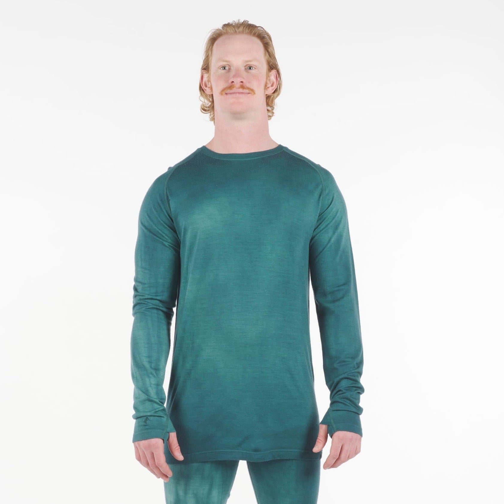 a man wearing an Aspect base layer shirt in Treetop Dye with matching bottoms