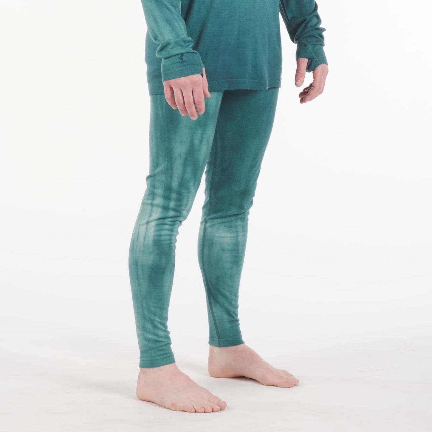 a man wearing Aspect Base Layer Bottoms in Treetop Garment Dye