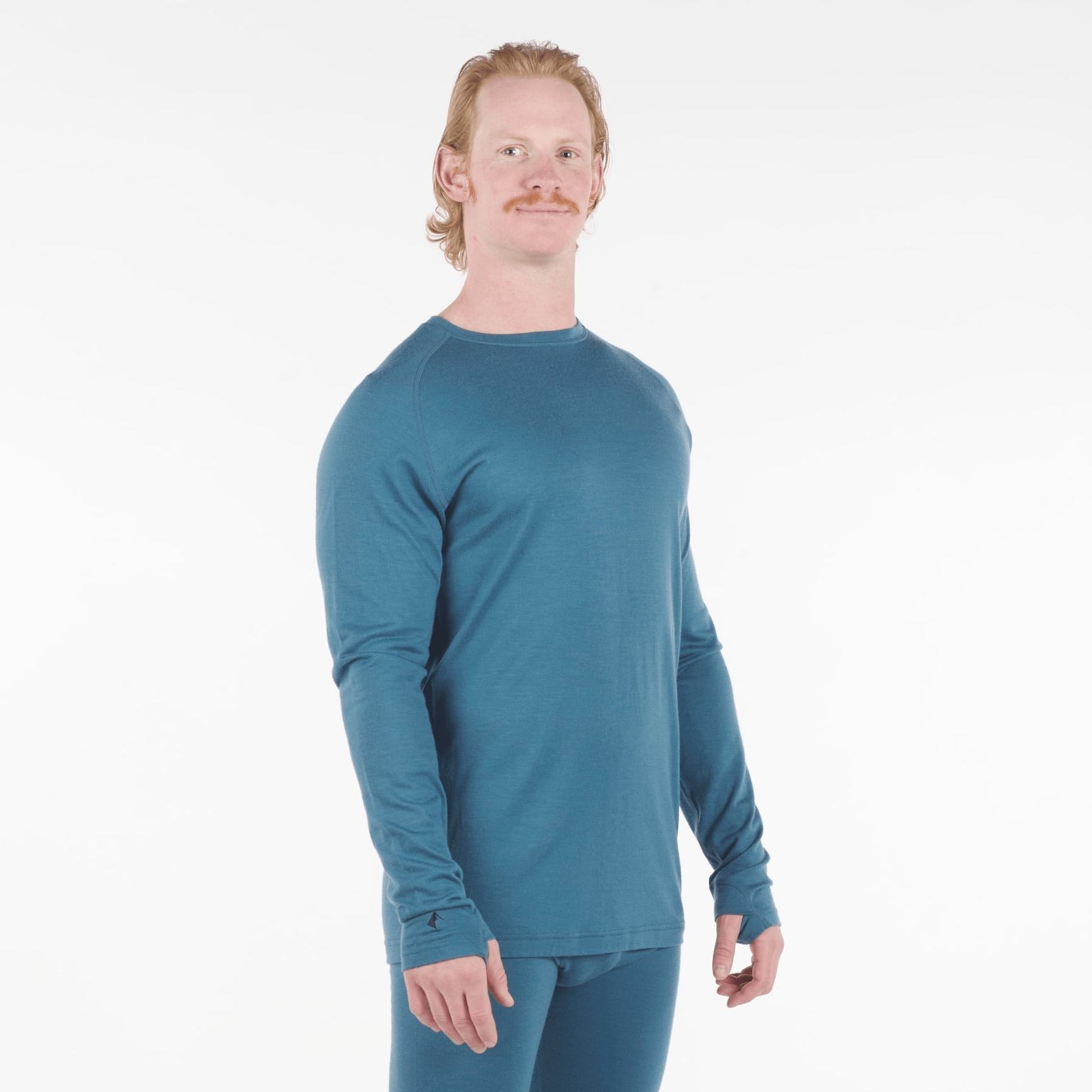 a man wearing an Aspect base layer shirt in Lagoon with matching bottoms
