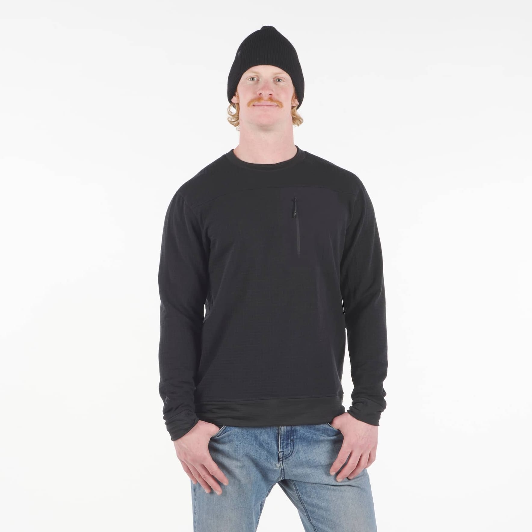 a man wearing a Cloudripper Crew Pullover in black with blue jeans and a black beanie