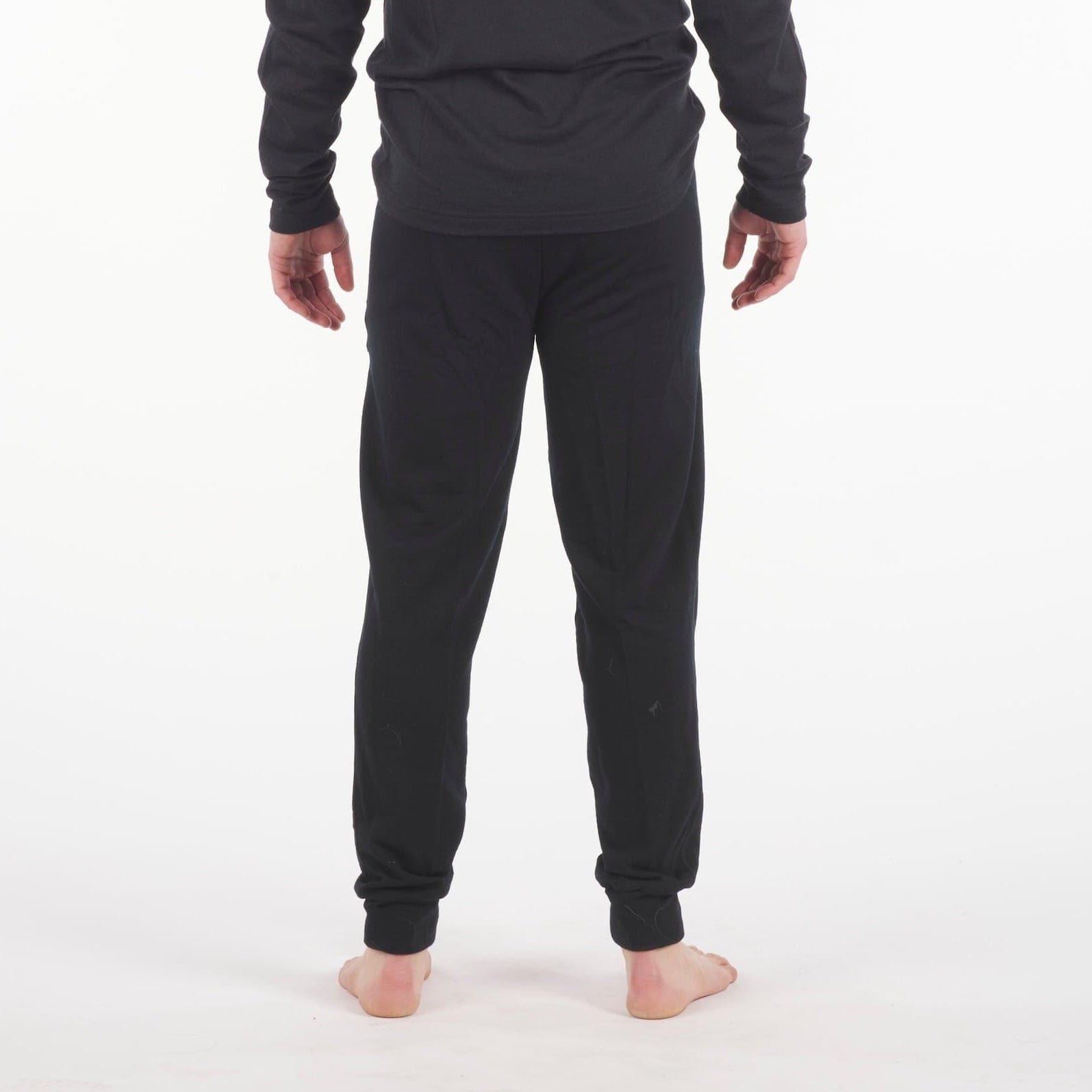 man in black Ridge Merino 100% Merino Hyde Joggers and an Aspect Long Sleeve Shirt
