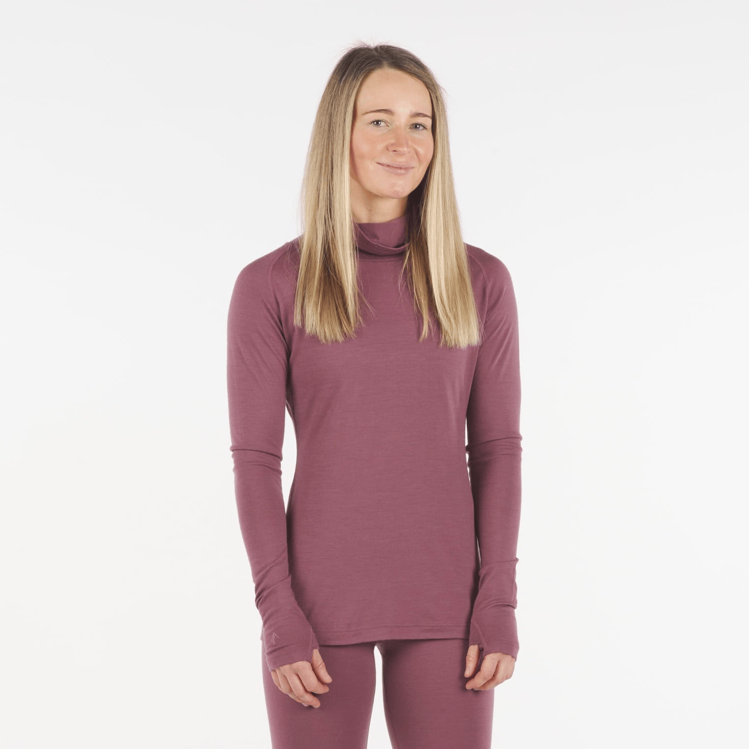 a woman wearing an Aspect High Neck Top in Soft Plum with matching bottoms